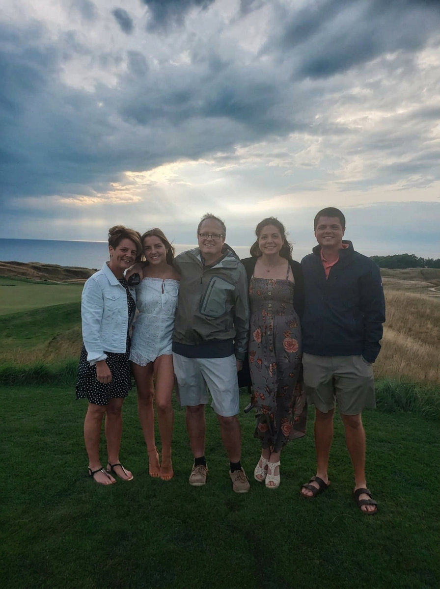 Ben Roeder with his family on a coastal golf course at sunset